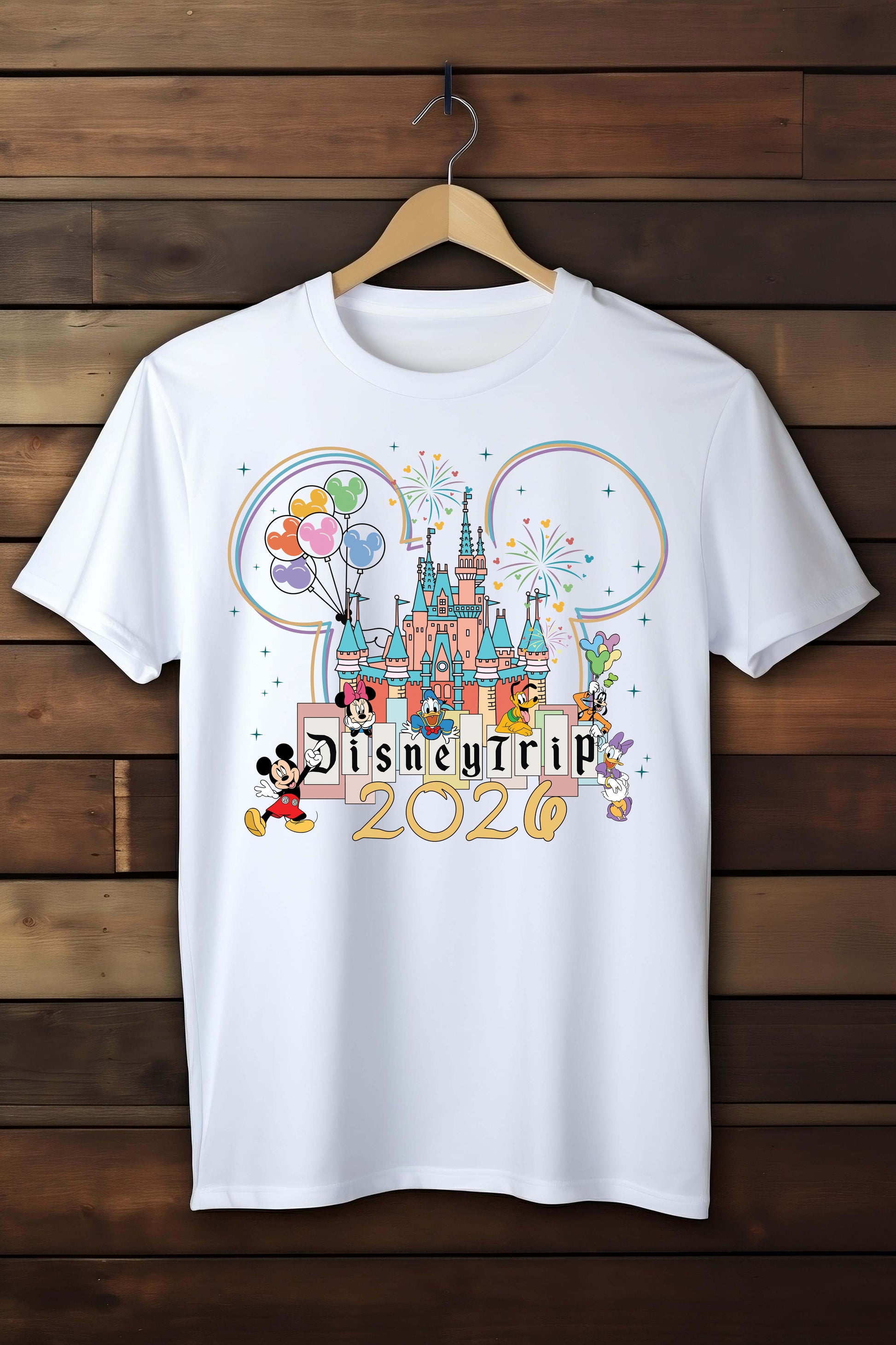White t-shirt with Disney-themed design on a wooden background