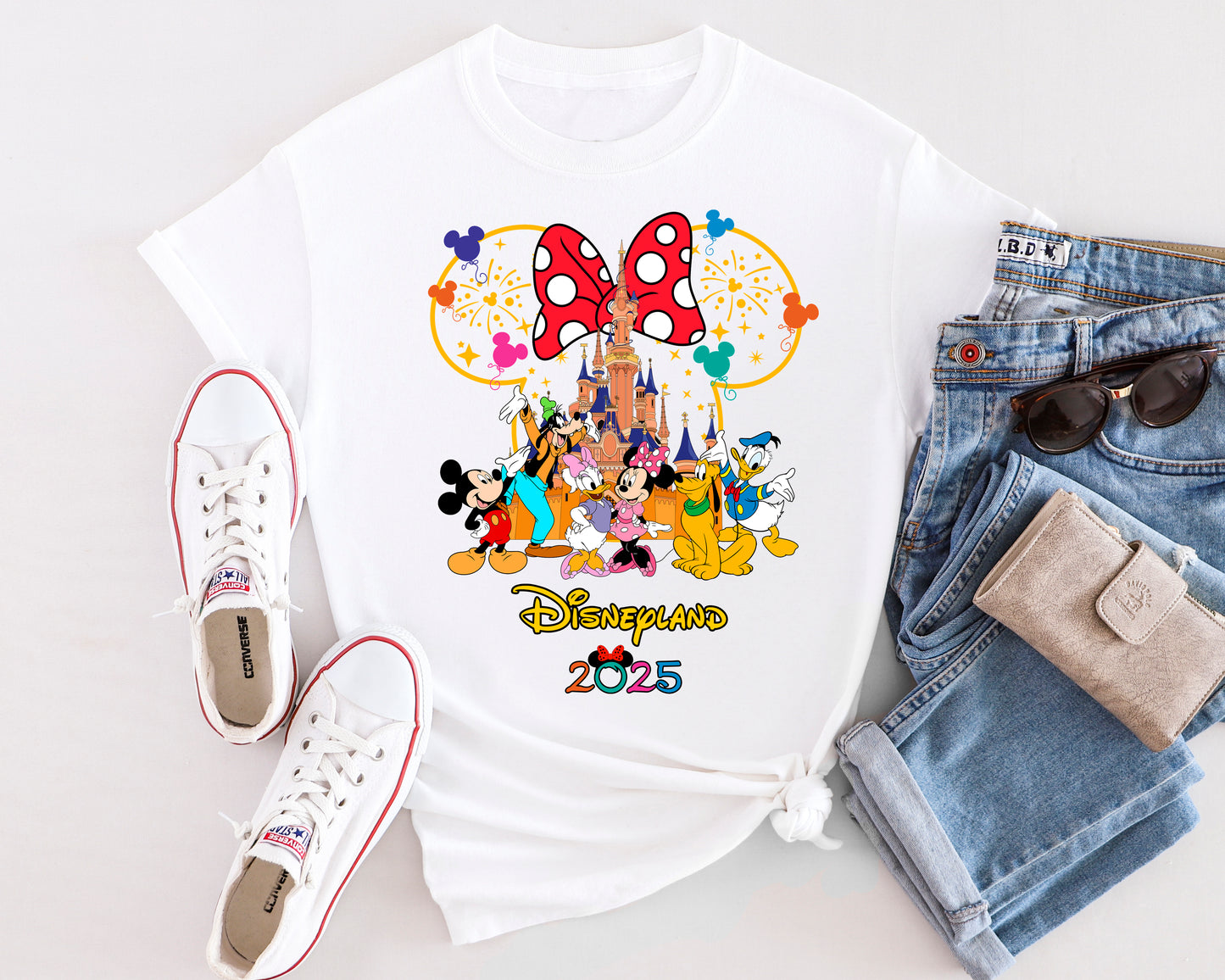 Golden Magical Dreams t-shirt with gold-accented Disney-style design, laid flat on a soft background.