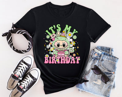 Mint green Labubu birthday party t-shirt featuring monster character design with balloon and gift details.