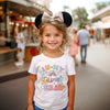Front view of Rainbow Castle Era Disney Inspired T-Shirt showing vibrant castle design on soft cotton fabric