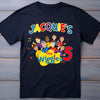 Black t-shirt with 'The Wiggles' design and text on a wooden background