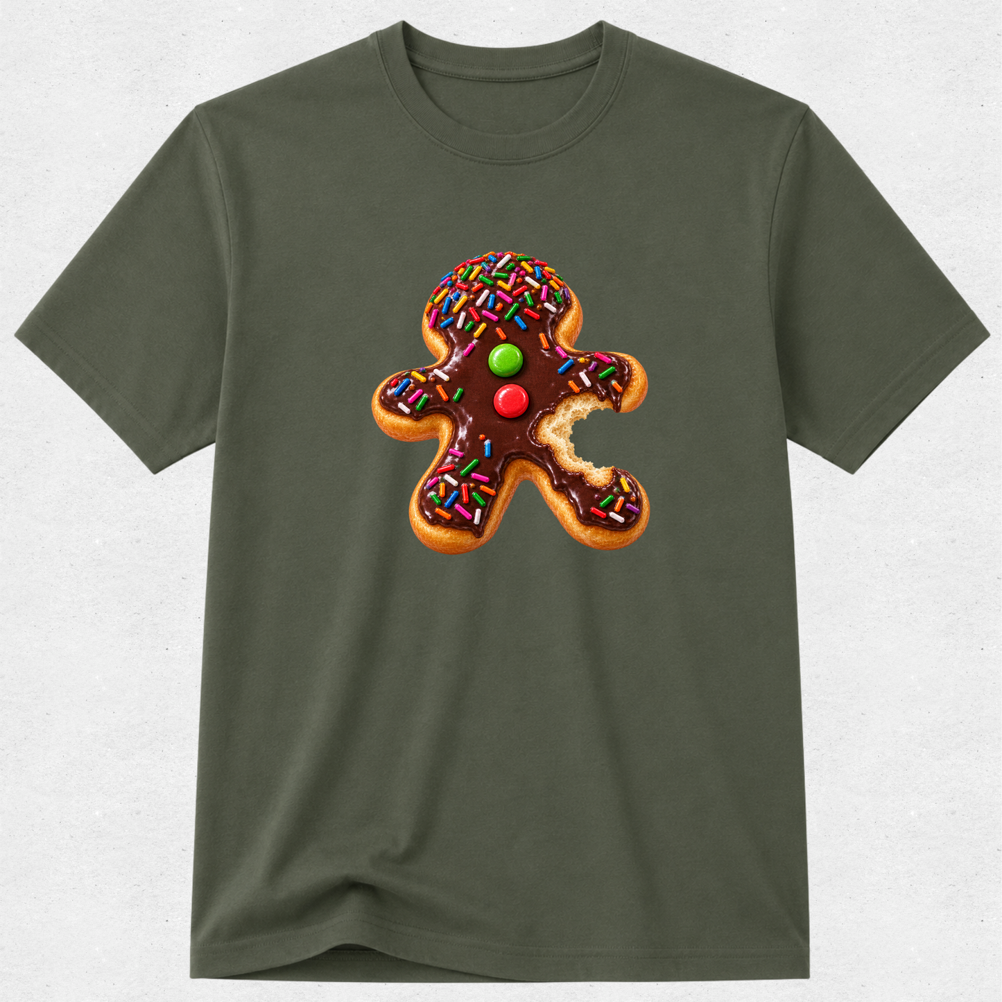 An olive green short-sleeve crewneck t-shirt featuring a graphic print of a gingerbread man cookie decorated with chocolate frosting, colorful sprinkles, and candy eyes.