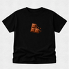 A black short-sleeve crewneck t-shirt featuring a graphic of a broken chocolate bar on the center chest, displayed flat against a light gray textured background.