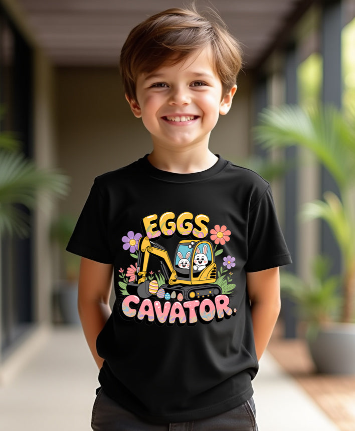 Child wearing a black t-shirt with colorful graphic and text outdoors