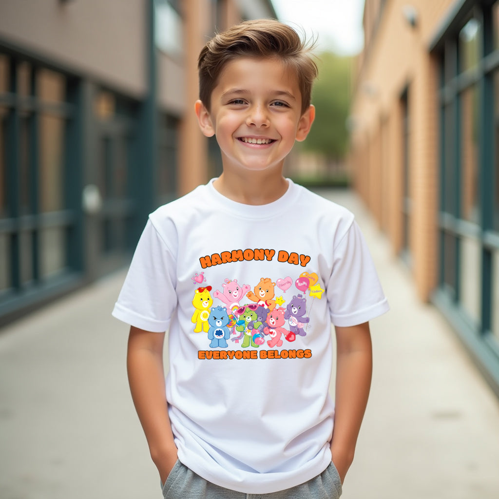 Child wearing a white t-shirt with colorful graphics and text, standing in an outdoor setting.