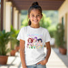 Young girl wearing a white t-shirt with colorful character kpop and easter design outdoors.