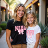 Woman and young girl wearing matching t-shirts with 'MAMA' and 'MINI' text.