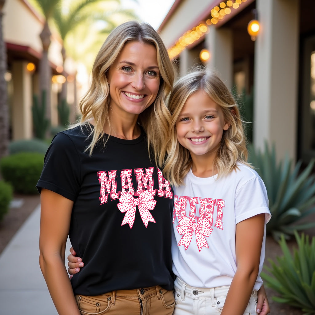 Woman and young girl wearing matching t-shirts with 'MAMA' and 'MINI' text.