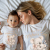 Woman and child wearing matching 'Our First Mother's Day' t-shirts with koala designs.