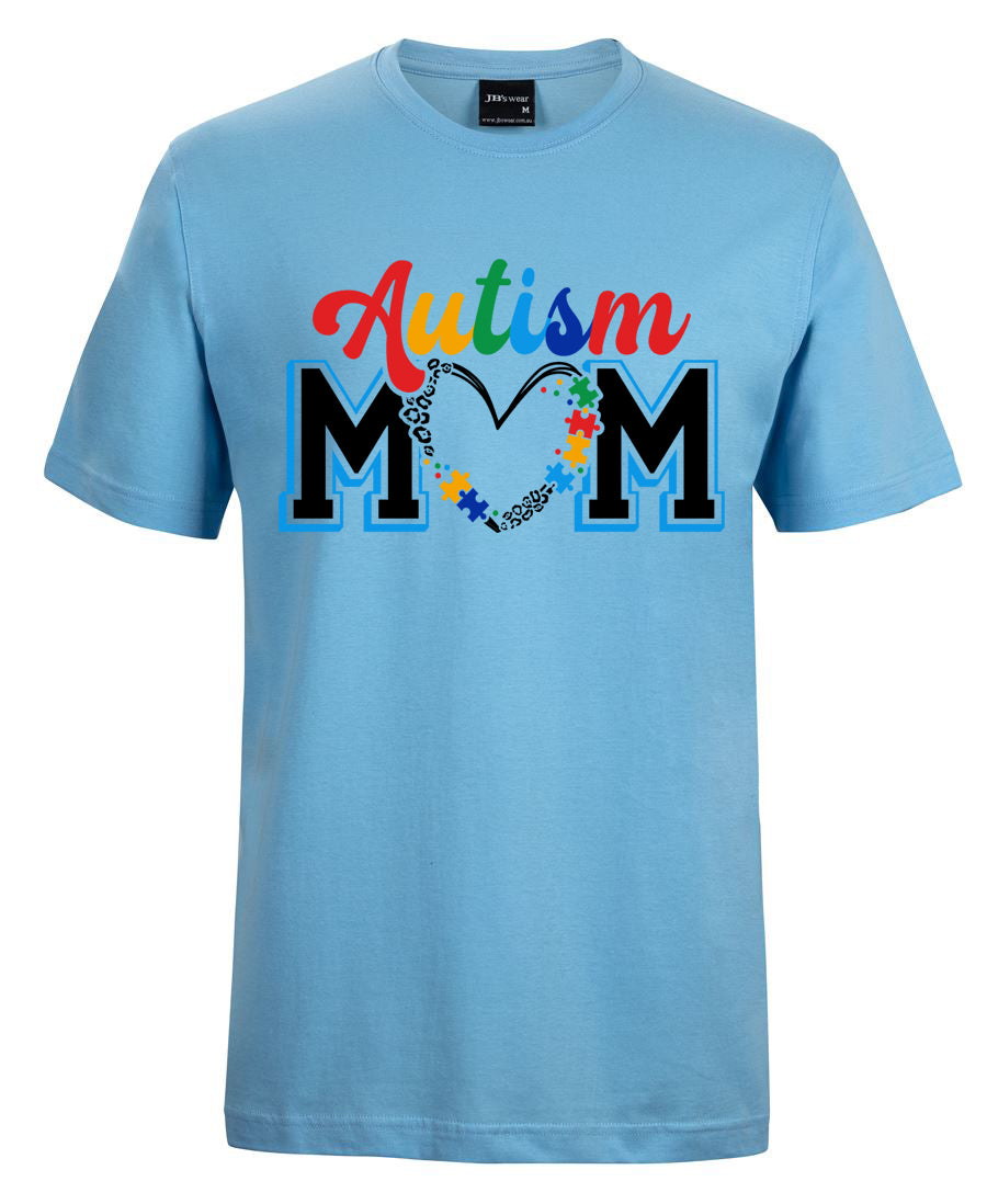 Light blue t-shirt with 'Autism Mom' text and colorful design on a white background