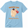 A light blue short-sleeve t-shirt with a custom 'Fathers Day' graphic featuring cartoon bears and the text 'FATHERS DAY 2026 Daddy & Nicholas' in orange and brown, displayed on a clean white background.