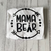 White shirt with 'Mama Bear' text on a wooden surface