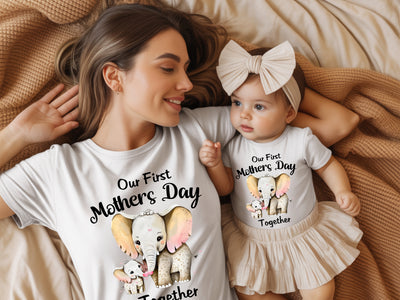 Woman and baby wearing matching 'Our First Mother's Day Together' shirts and outfits.