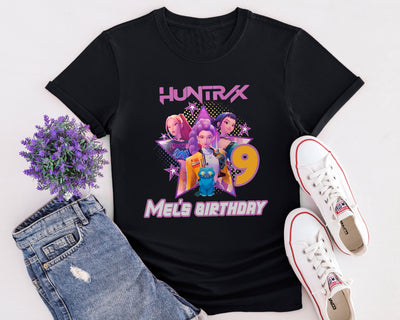 Flat lay of K-Pop Demon Hunters inspired t-shirt featuring animated pop group design in Netflix anime style.