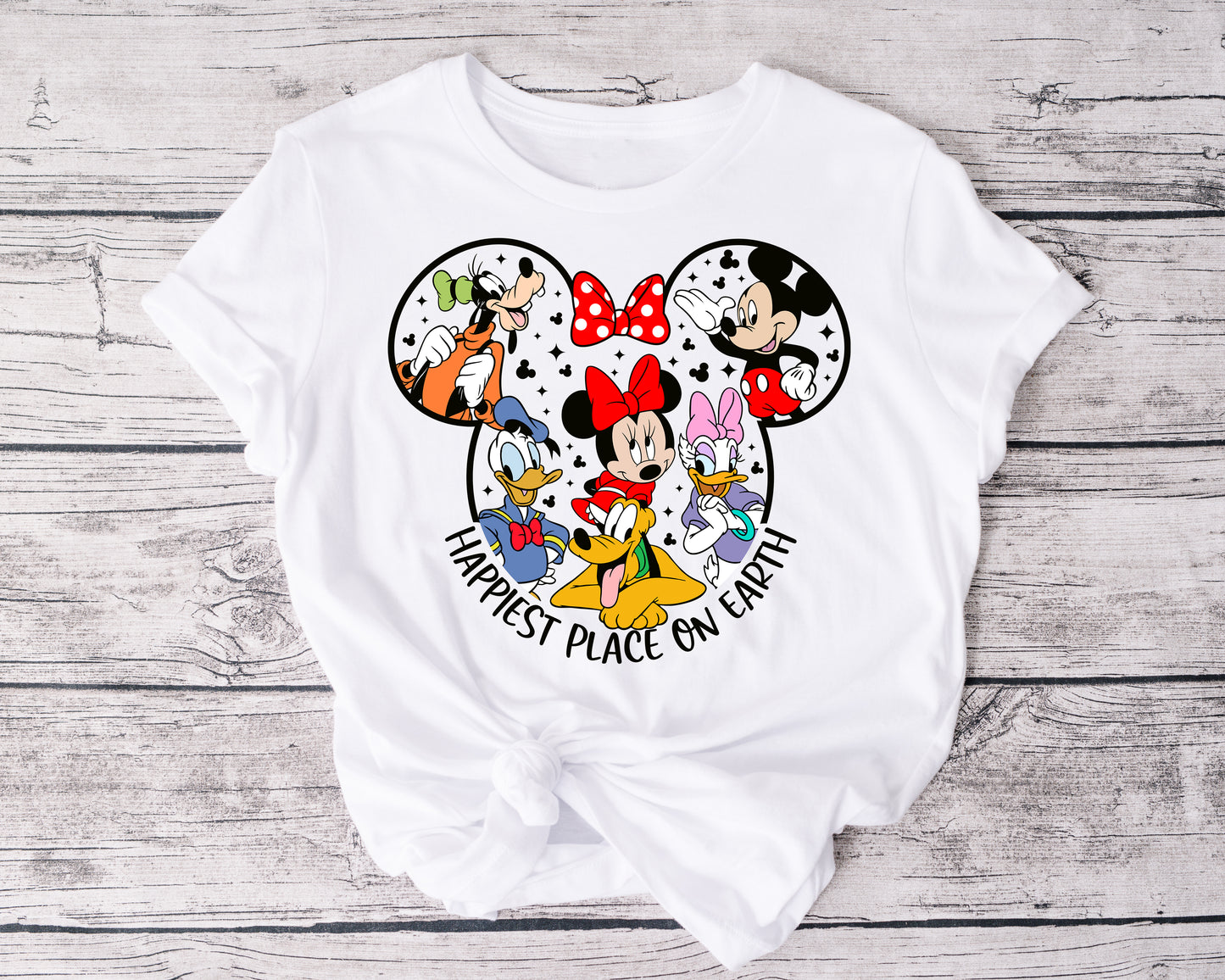Family or group wearing matching Happiest Place on Earth tees, smiling and celebrating together.