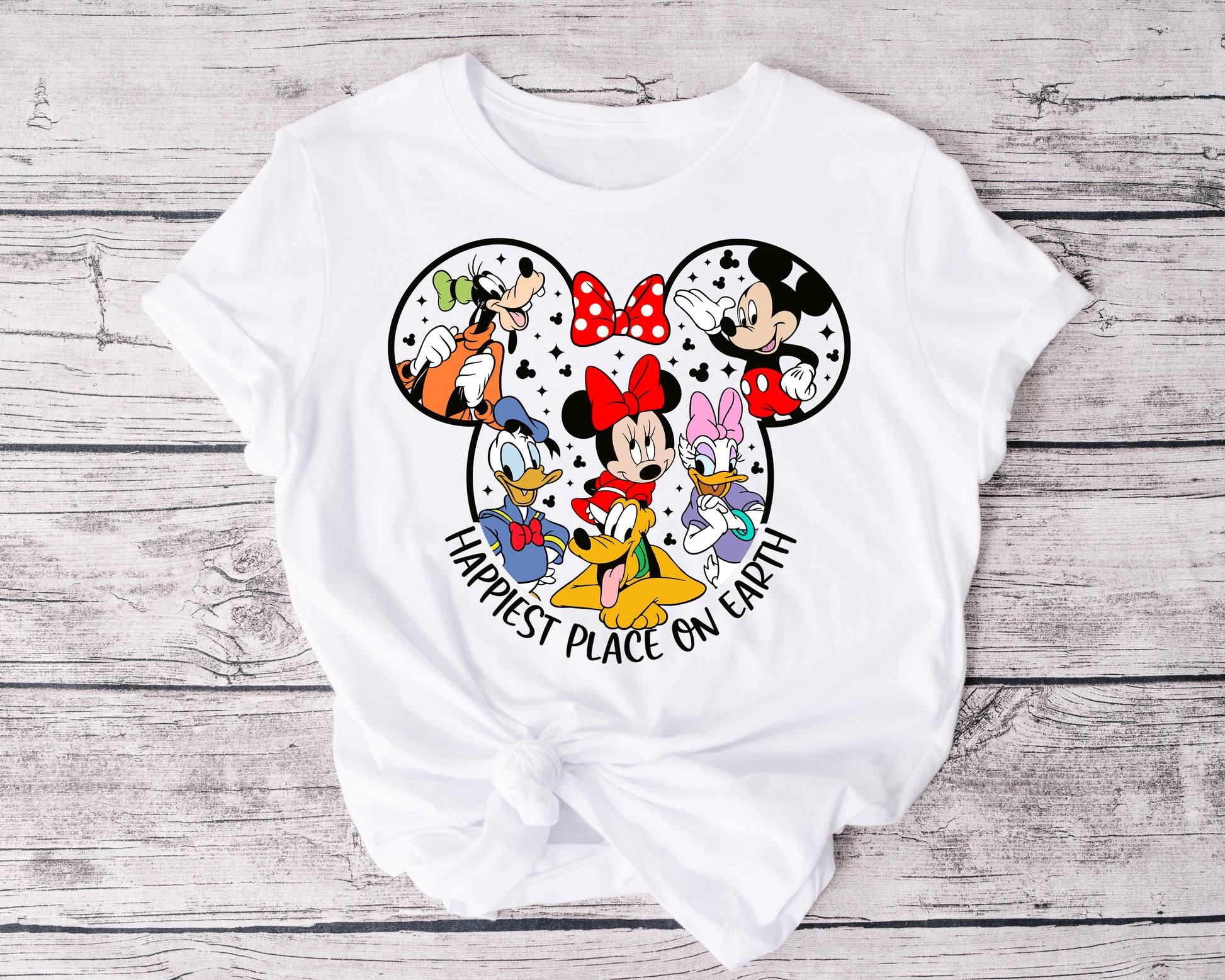 Family or group wearing matching Happiest Place on Earth tees, smiling and celebrating together.
