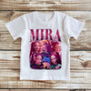 White t-shirt with 'Mira' graphic design on a wooden surface