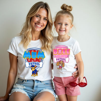 Woman and child wearing 'Mum Patrol' and 'Bree Patrol' t-shirts with cartoon characters.