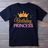 Black t-shirt with 'Birthday Princess' text and crown graphic on a wooden background