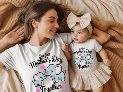 Woman and baby wearing matching 'First Mother's Day Together' shirts with elephant graphics.