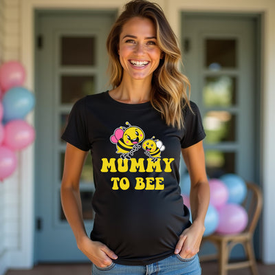 Woman wearing a black t-shirt with 'Mummy to Bee' design in front of balloons.