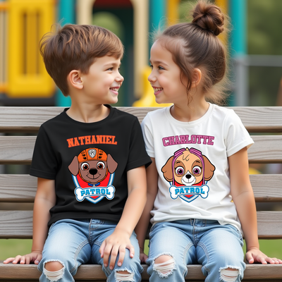 Two children sitting on a bench wearing personalized 'Paw Patrol' t-shirts.