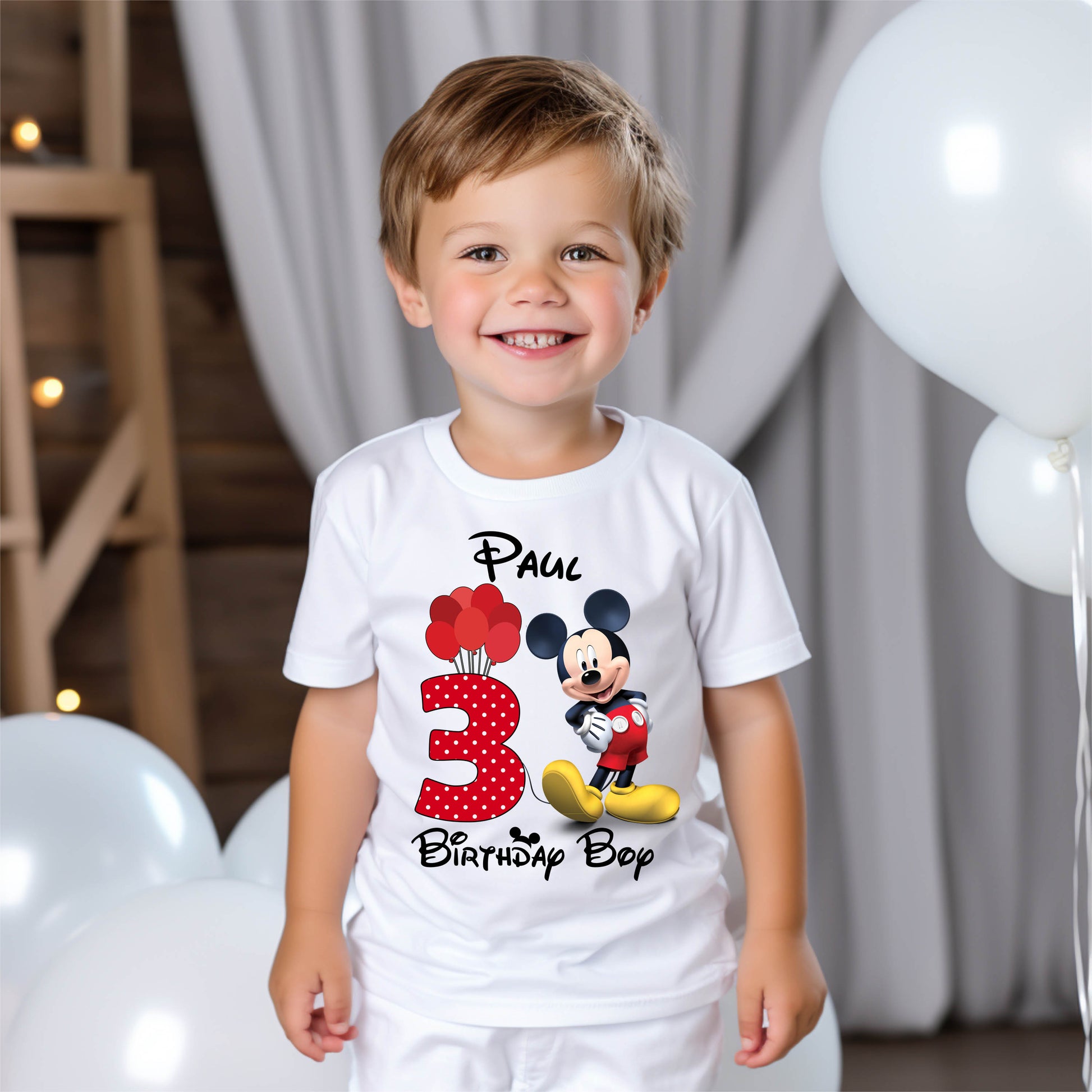 Child wearing a Disney-style mouse birthday t-shirt at a party or celebration.