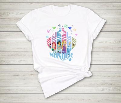 White t-shirt with colorful Disney princess design on a wooden surface