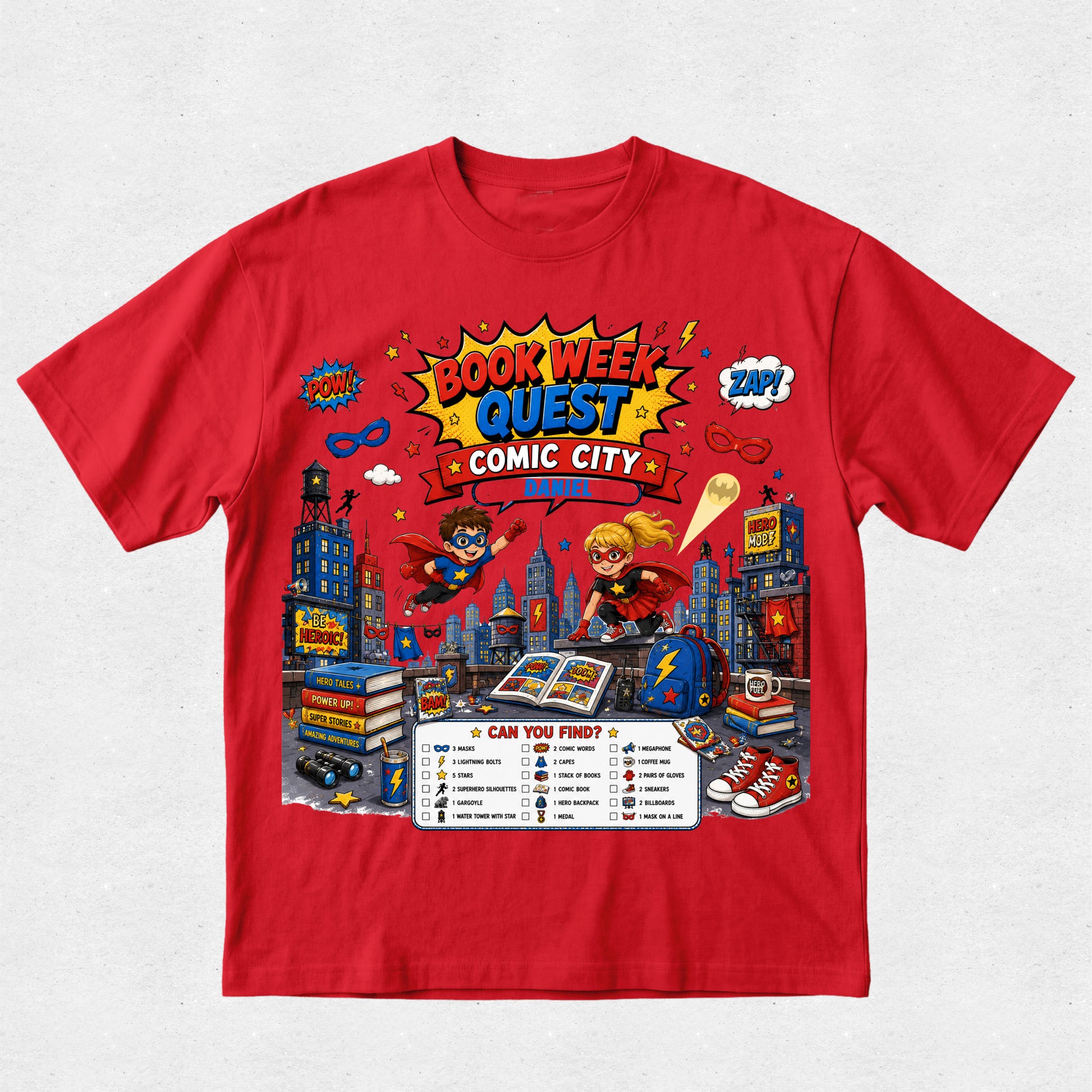 A red short-sleeve crewneck t-shirt featuring a colorful graphic print for 'Book Week Quest Comic City' on a light gray textured background.