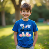 Child wearing a blue t-shirt with bunny ears and 'Sebastian' text in a park setting