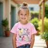 Young girl wearing a pink kpop easter t-shirt with a colorful graphic design outdoors.