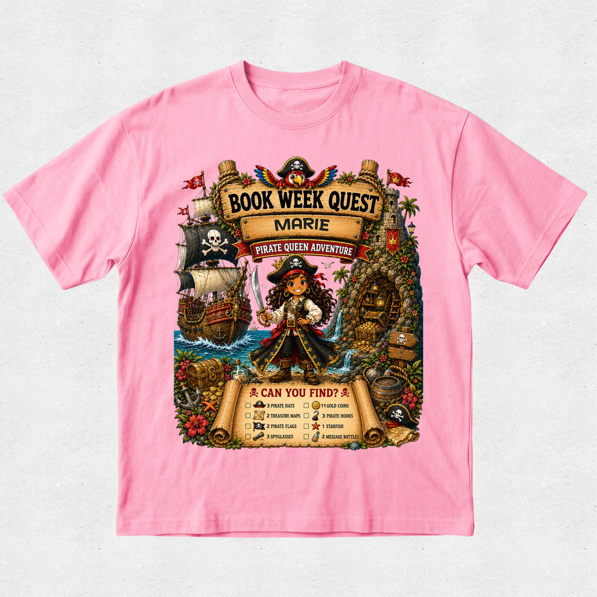 A pink short-sleeve crewneck t-shirt featuring a large, colorful pirate-themed graphic on the front. The graphic depicts a pirate woman named Marie on a treasure map labeled 'Book Week Quest Marie' and 'Pirate Queen Adventure', surrounded by a pirate ship, treasure chest, and a checklist titled 'Can You Find?'.