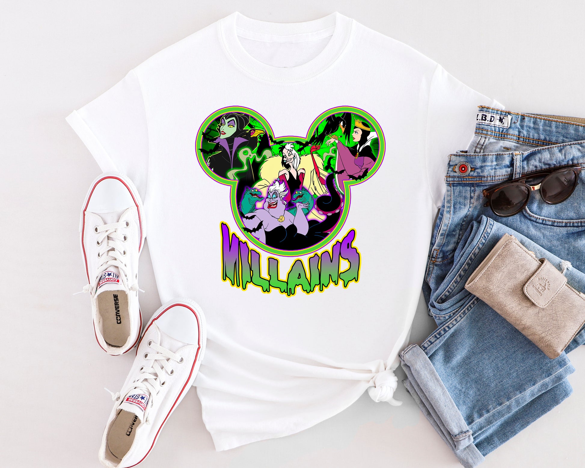 Flat lay of Villain Vibes shirt styled with jeans and accessories for Halloween or park day