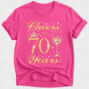 Pink t-shirt with 'Cheers to 70 Years' text and wine glass design on a white background