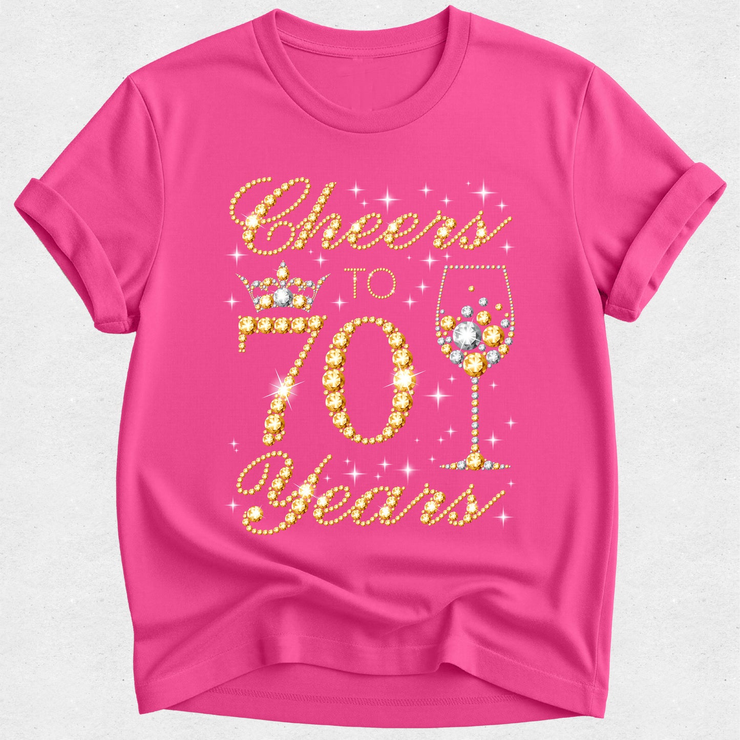 Pink t-shirt with 'Cheers to 70 Years' text and wine glass design on a white background