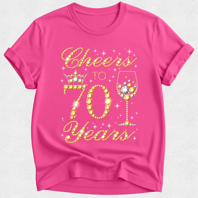 Pink t-shirt with 'Cheers to 70 Years' text and wine glass design on a white background