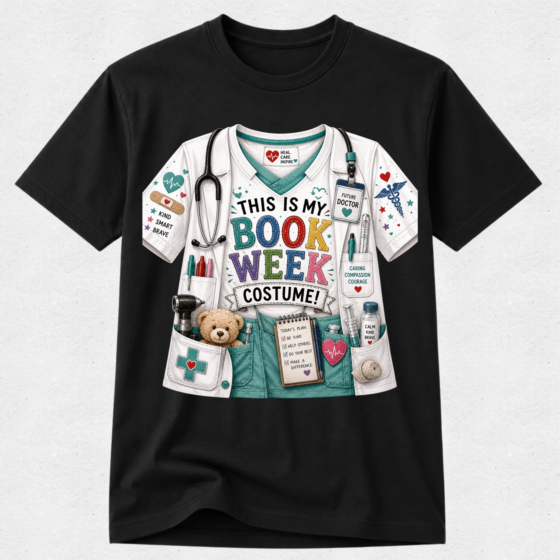 A black short-sleeve crewneck t-shirt featuring a colorful graphic print of a bookish doctor costume. The graphic depicts a white and teal scrub top with a stethoscope, medical badges, a teddy bear in a pocket, and the text 'THIS IS MY BOOK WEEK COSTUME!' in multicolored letters.
