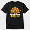 A black short-sleeve crewneck t-shirt with a colorful graphic on the chest. The graphic features a retro rainbow in yellow, orange, and white, with two small cartoon figures inside the rainbow.