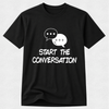 A black short-sleeve crewneck t-shirt with a white graphic of two speech bubbles and the text 'START THE CONVERSATION' printed on the front, displayed against a light gray textured background.