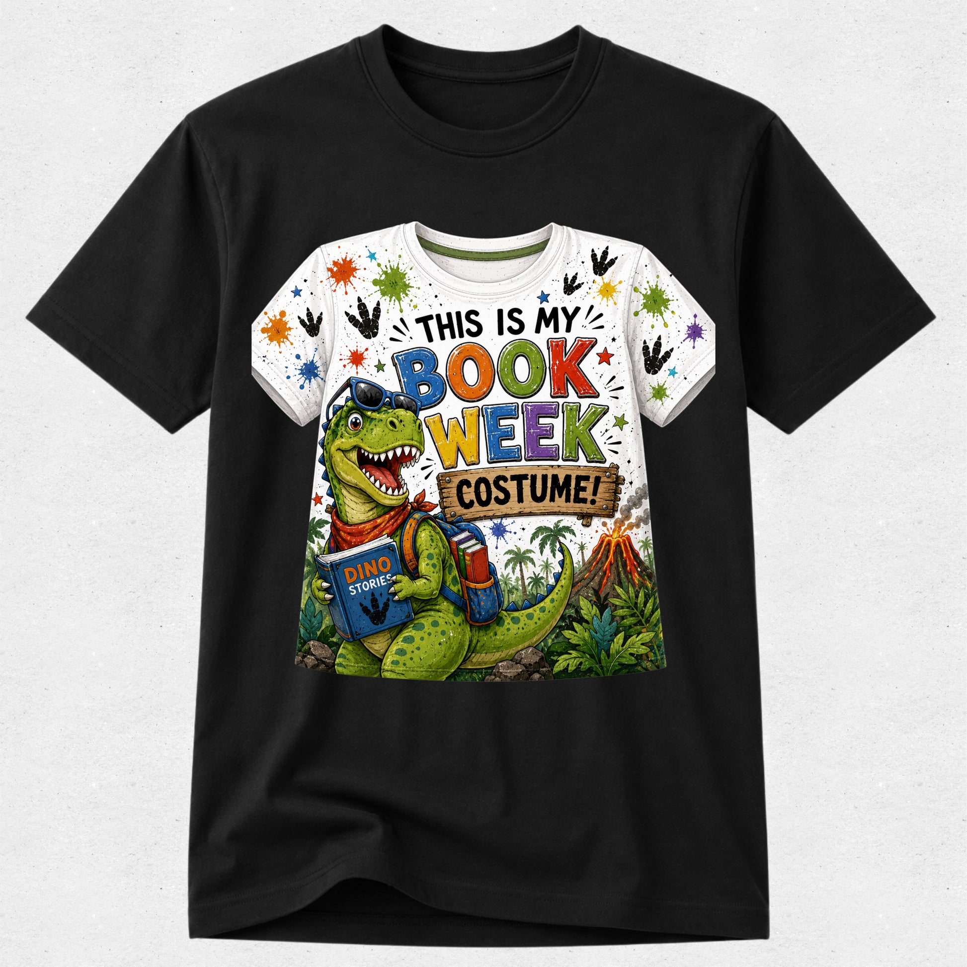 A black short-sleeve crewneck t-shirt featuring a colorful graphic print of a green dinosaur wearing a book-themed costume with the text 'THIS IS MY BOOK WEEK COSTUME!'.