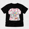 A black short-sleeve crewneck t-shirt featuring a colorful graphic print of a white medical costume shirt with the text 'THIS IS MY BOOK WEEK COSTUME!' and various book-themed illustrations.