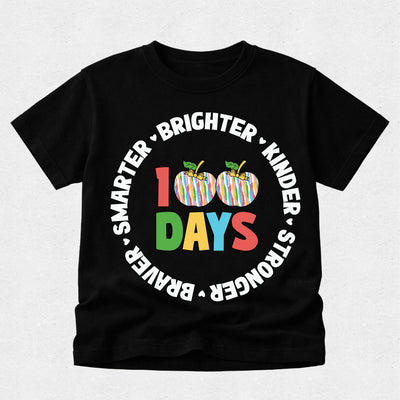 A black short-sleeve t-shirt with a colorful graphic celebrating 100 days. The design features two striped apples with green leaves, the number '100' in red and green, the word 'DAYS' in multicolor letters, and white text arched around them reading 'SMARTER • BRIGHTER • KINDER • STRONGER'.