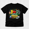 Black t-shirt with colorful '100 Days of Prep' design featuring an apple, books, and a science beaker on a light gray background.