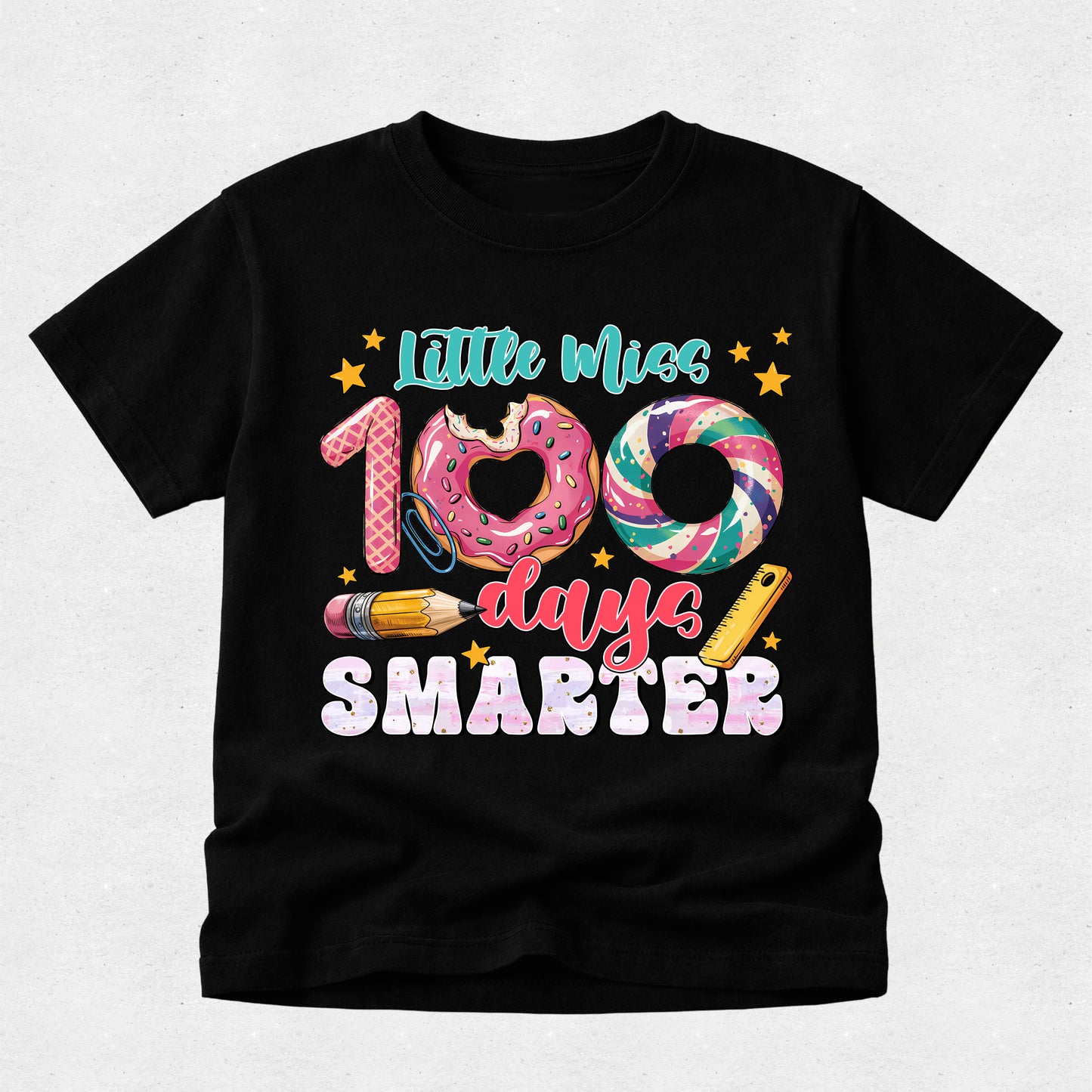 A black short-sleeve t-shirt with a colorful graphic on the front that reads 'Little Miss 100 days SMARTER' with donut, swirl, pencil, and star illustrations, shown on a light gray background.