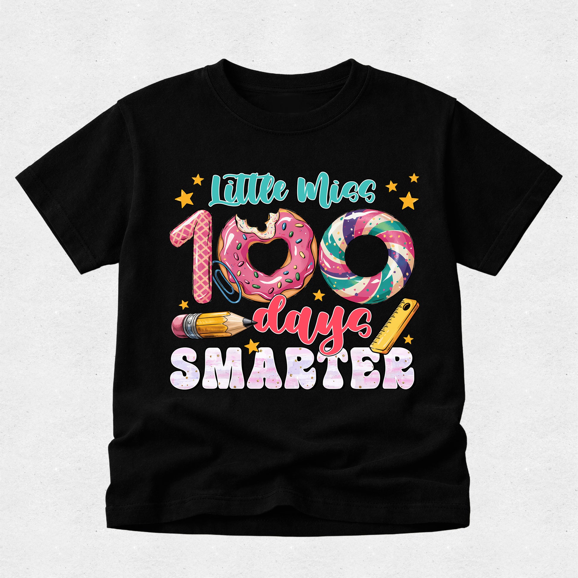 A black short-sleeve t-shirt with a colorful graphic on the front that reads 'Little Miss 100 days SMARTER' with donut, swirl, pencil, and star illustrations, shown on a light gray background.