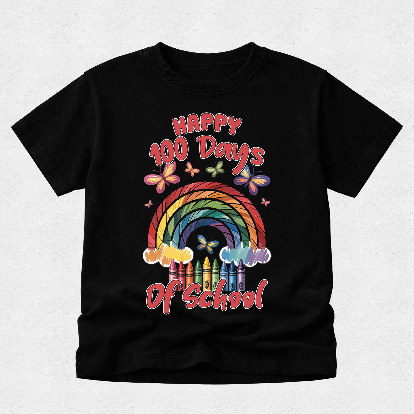 A black short-sleeve t-shirt with a colorful graphic on the front that reads 'Happy 100 Days Of School' above and below a rainbow made of crayons, with butterflies around it, shown on a light gray background.
