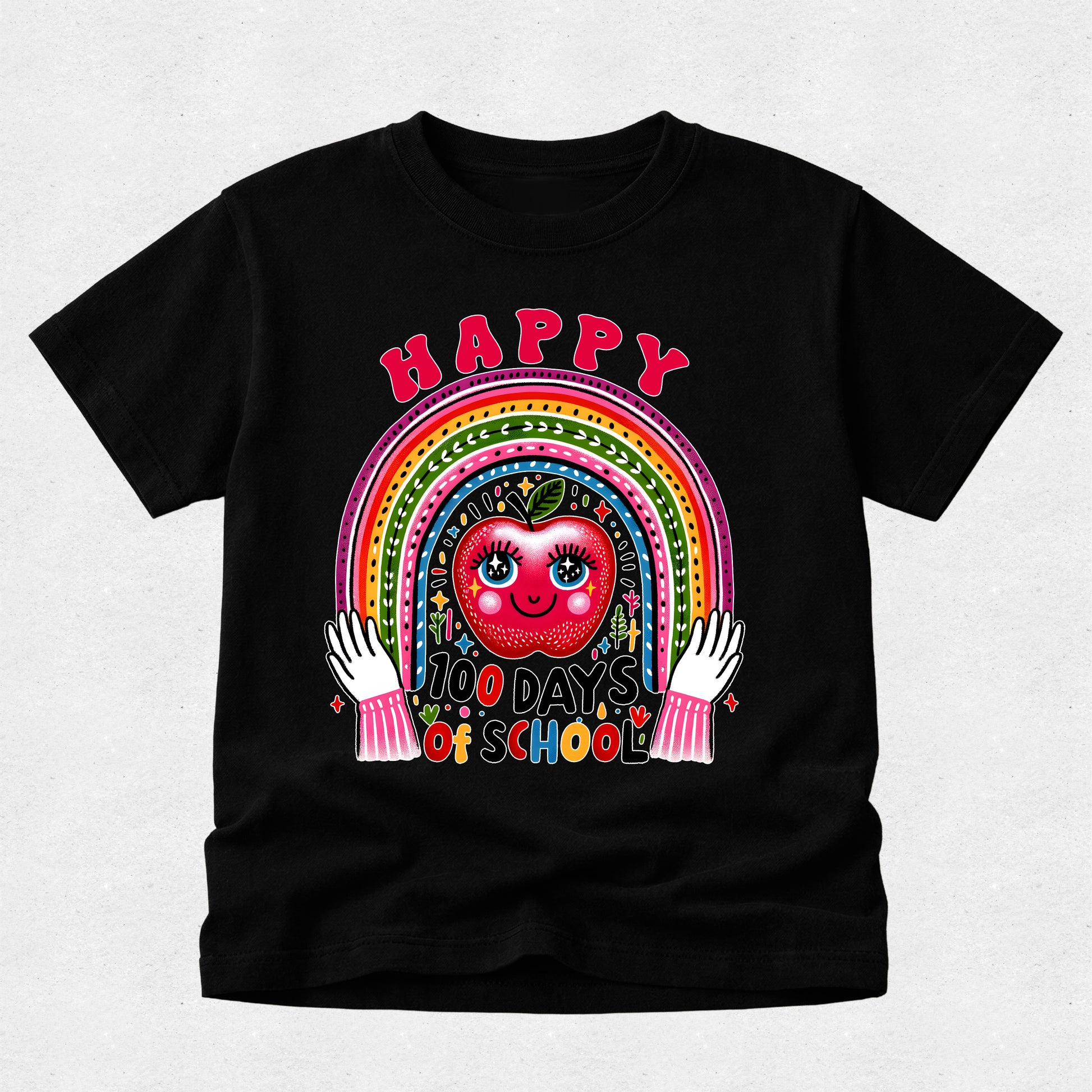 A black short-sleeve t-shirt with a colorful graphic on the front featuring a smiling red apple, a rainbow, and the text 'HAPPY 100 DAYS OF SCHOOL' with white hands holding the design.
