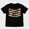 A black short-sleeve t-shirt with a colorful graphic that reads '100 DAYS TO SCHOOL' decorated with school-themed illustrations like apples, books, and bows, shown on a light gray background.