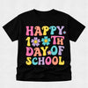 A black short-sleeve kids' t-shirt featuring a colorful graphic that reads 'HAPPY 10TH DAY OF SCHOOL' in playful, multicolored bubble letters with smiley faces and flowers.