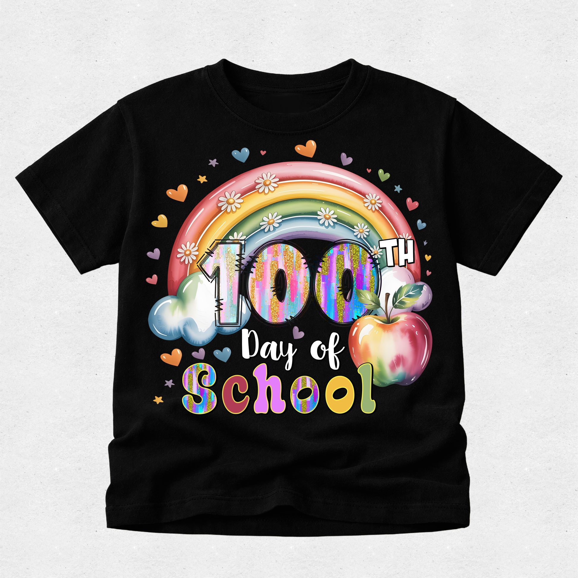A black short-sleeve t-shirt with a colorful graphic celebrating '100th Day of School' featuring a rainbow, clouds, hearts, and an apple on a light gray background.
